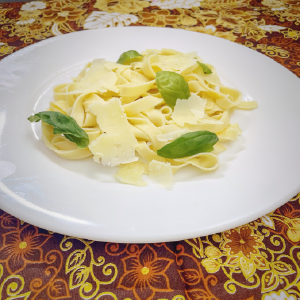 Fresh pasta with truffle oil and basil leaves